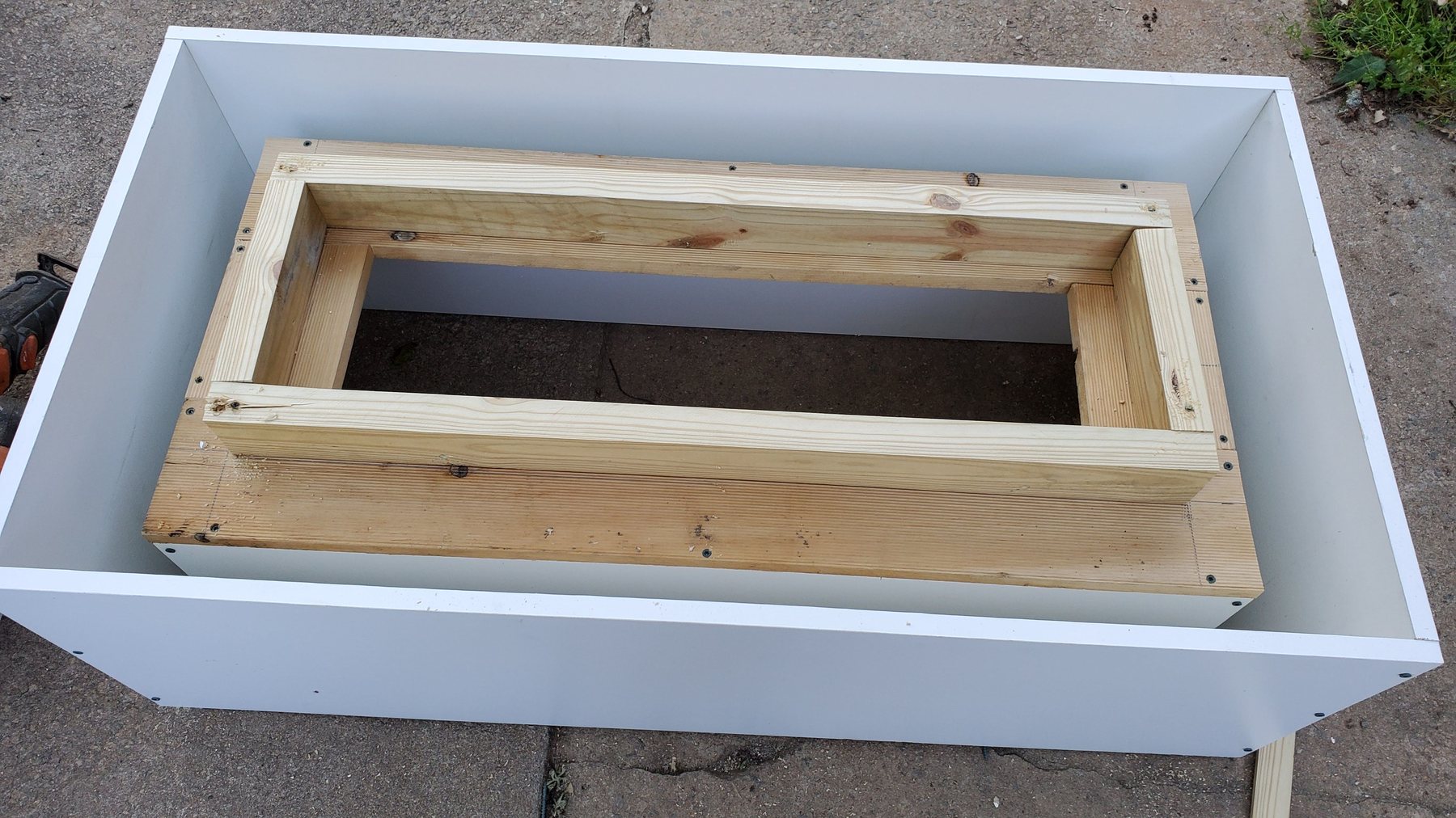 Wood form used to build an Eleven17 custom concrete gas fire table